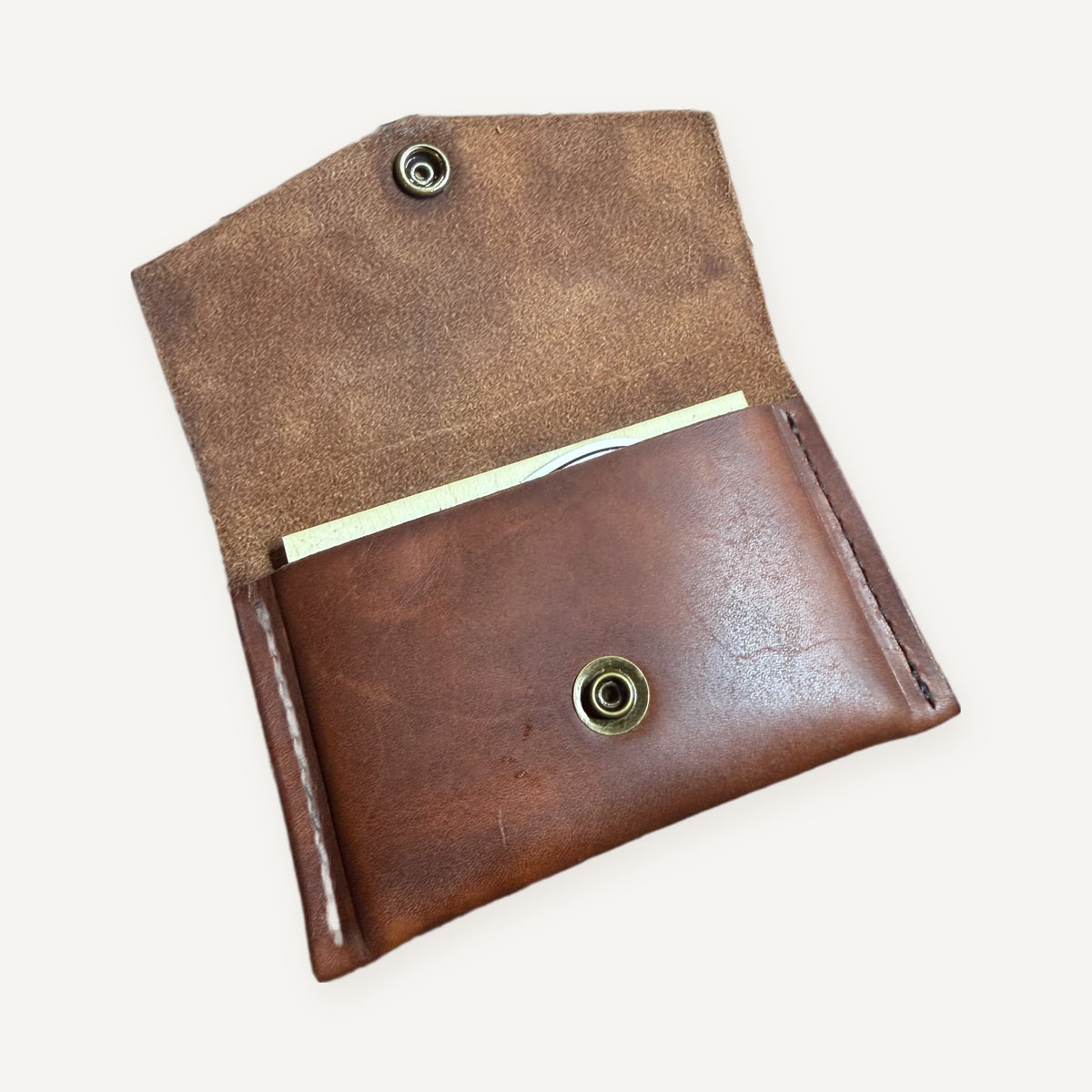 Leather trading card pouch open, showing a stack of pilot trading cards inside